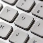 Close-up of white computer keyboard keys, symbolizing writing and running the Python code in this LangGraph tutorial