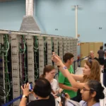 Rows of server racks in a data center computer room, representing a Kubernetes fleet spread across many clusters