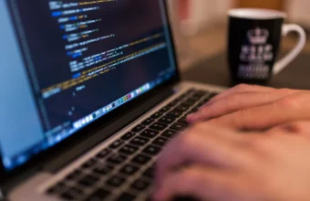 Computer programmer typing code on a laptop representing enterprise Java migration work
