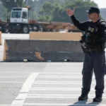Customs officers inspect shipping containers at a seaport