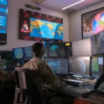 U.S. Space Force Guardians monitor workstations in an operations center at Vandenberg Space Force Base, illustrating continuous system observability.