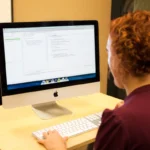 A programmer reviewing Java code with unit tests on a desktop computer screen