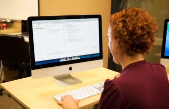 A programmer reviewing Java code with unit tests on a desktop computer screen