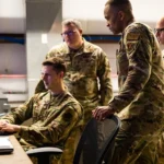 U.S. Air Force Staff Sgt. Tullis Moore and cyber operators from the 175th Cyber Operations, Maryland Air National Guard, monitor cyber activity during Exercise Southern Strike