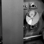 Close-up of a bank vault door combination dial locks and multi-spoke locking wheel, representing layered protection for encrypted secrets
