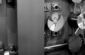 Close-up of a bank vault door combination dial locks and multi-spoke locking wheel, representing layered protection for encrypted secrets