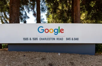 Google campus sign reading Google, 1565 and 1585 Charleston Road, B45 and B46, surrounded by redwood trees