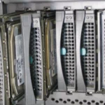 Close-up of hot-swap hard drive bays in a rack-mount Fujitsu Siemens Primergy server, the kind of physical hardware MAAS discovers and provisions