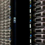 Close-up of dark data center server racks with blue status lights, representing the kind of production infrastructure involved in the OpenAI and Hugging Face security incident