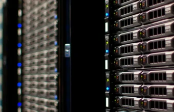 Close-up of dark data center server racks with blue status lights, representing the kind of production infrastructure involved in the OpenAI and Hugging Face security incident