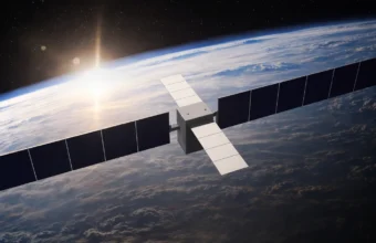 3D render of a datacenter satellite with solar panel arrays orbiting above Earth, backlit by the sun
