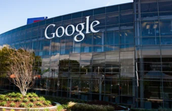 The Google logo on the glass facade of a building at Google's Googleplex headquarters