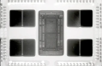 Near-infrared macro photograph of a delidded AMD EPYC 7702 server processor, showing the central I/O die and eight surrounding Core Complex Dies