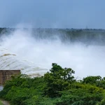 Floodwater rushes through an open spillway gate at the Narayanpur Dam on the Krishna River in Karnataka, India