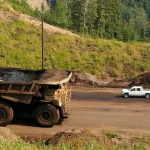 A large Caterpillar 797 mining haul truck on a mine site road