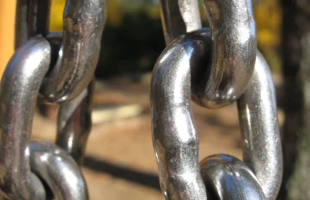 Close-up photograph of interlocking polished steel chain links