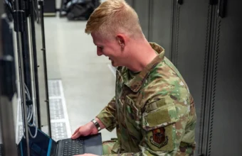 U.S. Air Force network systems technician performing server maintenance in a data center