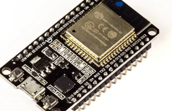 Close-up photo of an ESP32-WROOM-32 development board showing its micro USB port, module, GPIO pins, and EN and BOOT buttons used for flashing firmware