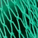 Extreme close-up of a green woven HDPE construction safety net