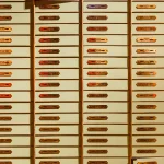 Rows of individually numbered, individually locked safe deposit boxes inside a bank vault