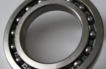 Close-up of a ball bearing showing individually spaced steel balls arranged evenly around a metal ring