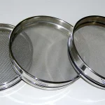 Three graduated stainless steel laboratory test sieves of decreasing mesh size, used to sort particles by size range