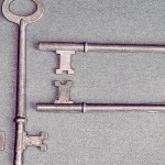 Four antique skeleton keys resting on a blue background