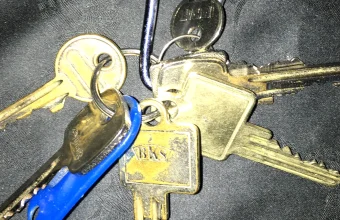 A cluster of physical keys on a keyring, representing the many permission scopes available versus the one a workflow actually needs
