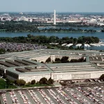 Aerial view of the Pentagon building in Arlington, Virginia, with the Washington Monument visible in the background