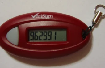 A red VeriSign hardware one-time-password token displaying a six-digit rotating code on its LCD screen