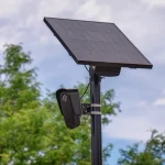 A solar-powered Flock Safety automated license plate reader camera mounted on a pole