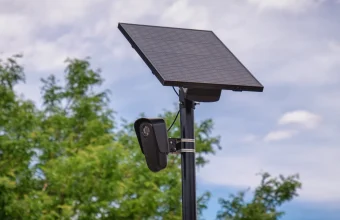 A solar-powered Flock Safety automated license plate reader camera mounted on a pole