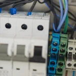 Close-up of circuit breaker switches and wiring terminals inside an electrical panel