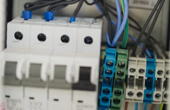 Close-up of circuit breaker switches and wiring terminals inside an electrical panel