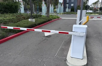 A closed red-and-white striped boom barrier blocking a parking entrance, representing a Content Security Policy blocking unauthorized scripts by default