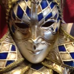 Close-up of an ornate gold and blue Venetian carnival mask