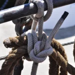Close-up photo of a clove hitch and square knot tied in rope and rigging aboard a sailing ship
