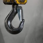 Industrial crane lifting hook with a safety latch, a visual metaphor for the Git hook mechanism exploited in this vulnerability