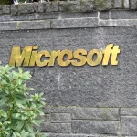 Stone entrance sign with the Microsoft logo in gold lettering at the company's Redmond campus