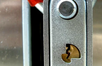 Close-up of a padlock and chain locking mechanism, representing verifying npm package integrity to block supply chain compromises