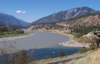 The muddy Fraser River meeting the blue-green Thompson River at their confluence near Lytton, British Columbia