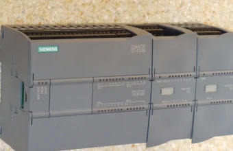 Siemens SIMATIC S7-1200 programmable logic controller with expansion modules, the type of device named in the CISA advisory