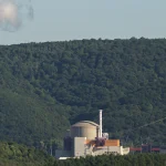 Cooling towers and dome-shaped reactor containment buildings at the Chooz Nuclear Power Plant in France, used as a visual metaphor for an AI containment plan