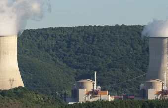 Cooling towers and dome-shaped reactor containment buildings at the Chooz Nuclear Power Plant in France, used as a visual metaphor for an AI containment plan