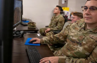 U.S. Air National Guard intelligence analysts monitor computer workstations while conducting defensive cyber operations