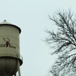 A municipal water tower in Minnesota against an overcast sky, representing the type of water infrastructure targeted in the attacks