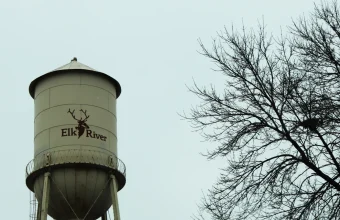 A municipal water tower in Minnesota against an overcast sky, representing the type of water infrastructure targeted in the attacks