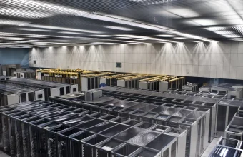 Rows of server racks seen from above in a data center, representing the physical hardware layer beneath AI inference and agent systems