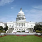 The west front of the United States Capitol building under a blue sky