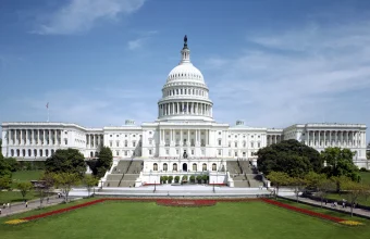 The west front of the United States Capitol building under a blue sky
